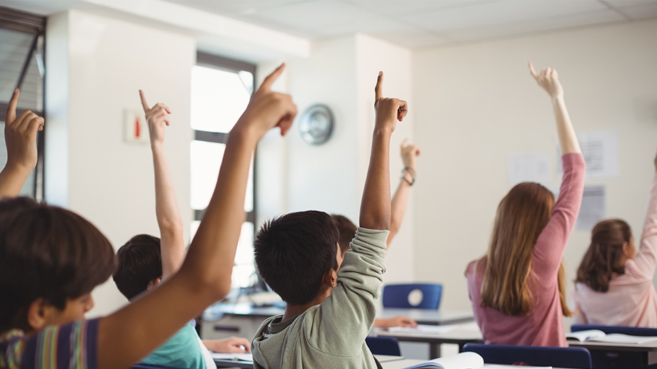 school-kids-raising-hand-in-classroom-2021-08-28-16-44-12-utc mod